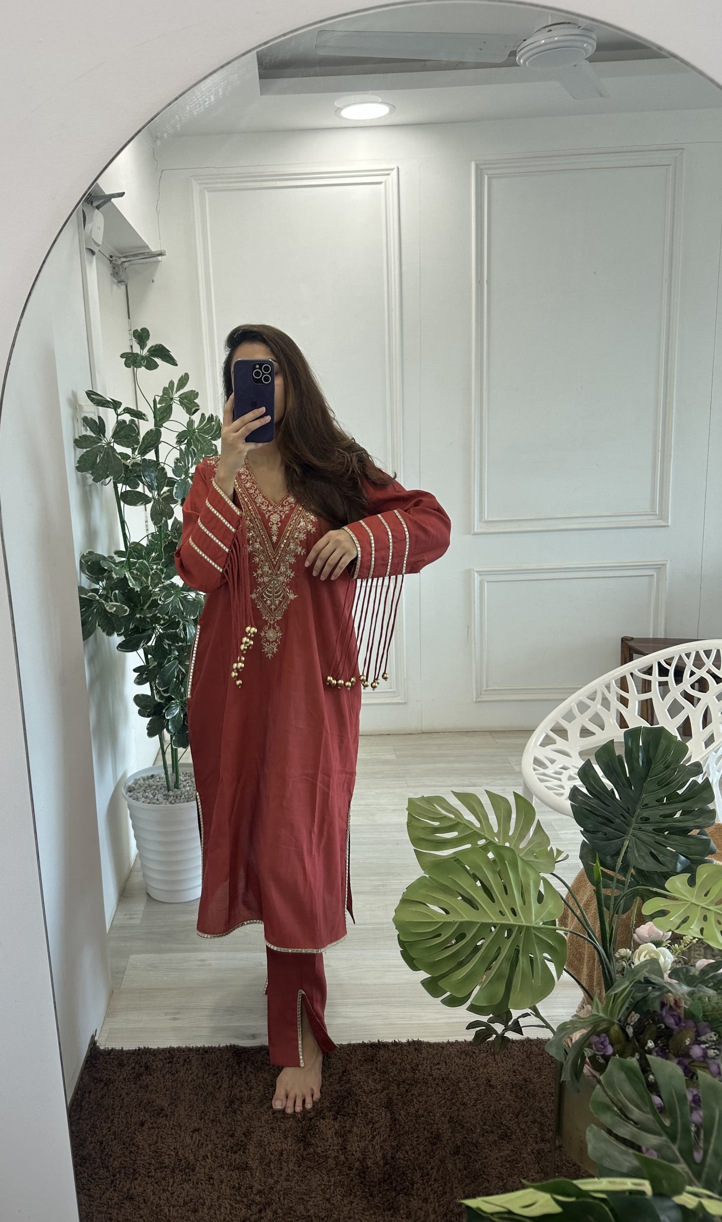 kurta with Handwork on the neck pocket and tassels on the sleeves along with straight pants